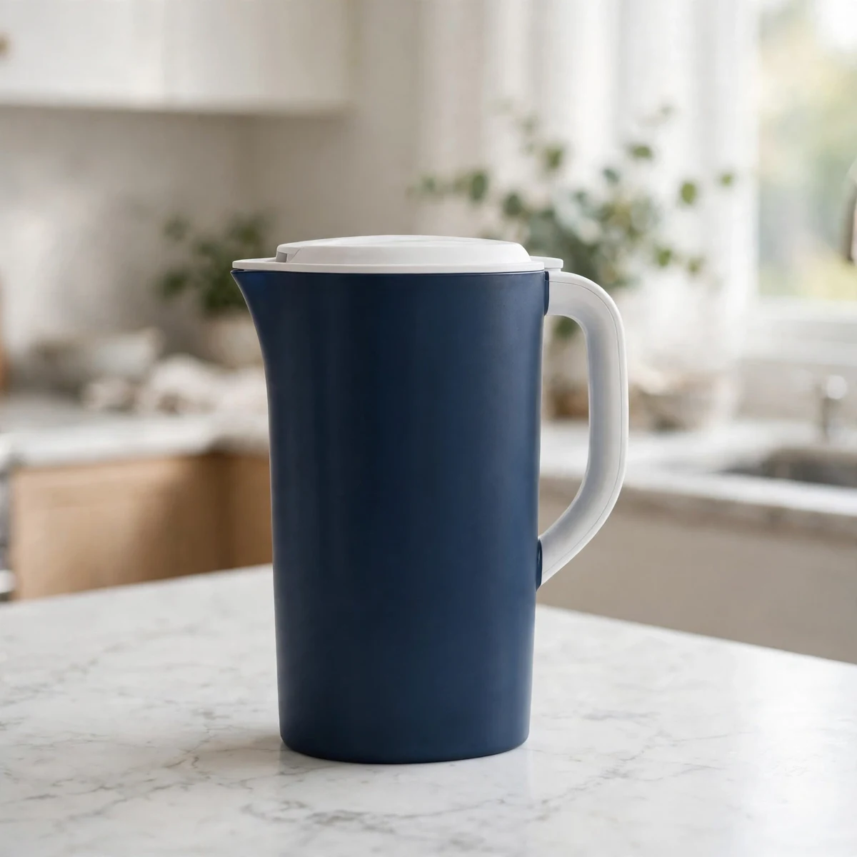 Brita dark-blue water filter pitcher with white lid on a marble counter