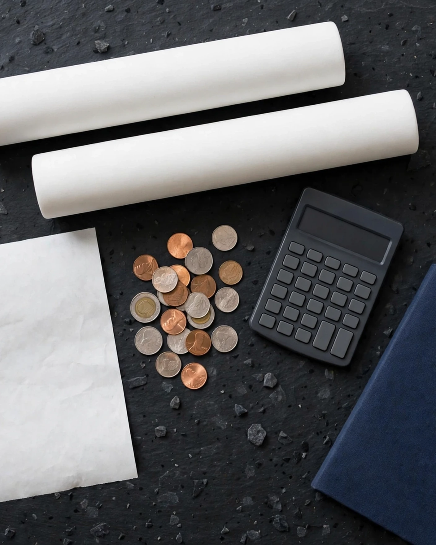 Ceramic filter candles with a calculator, coins and a receipt in a cost flat-lay