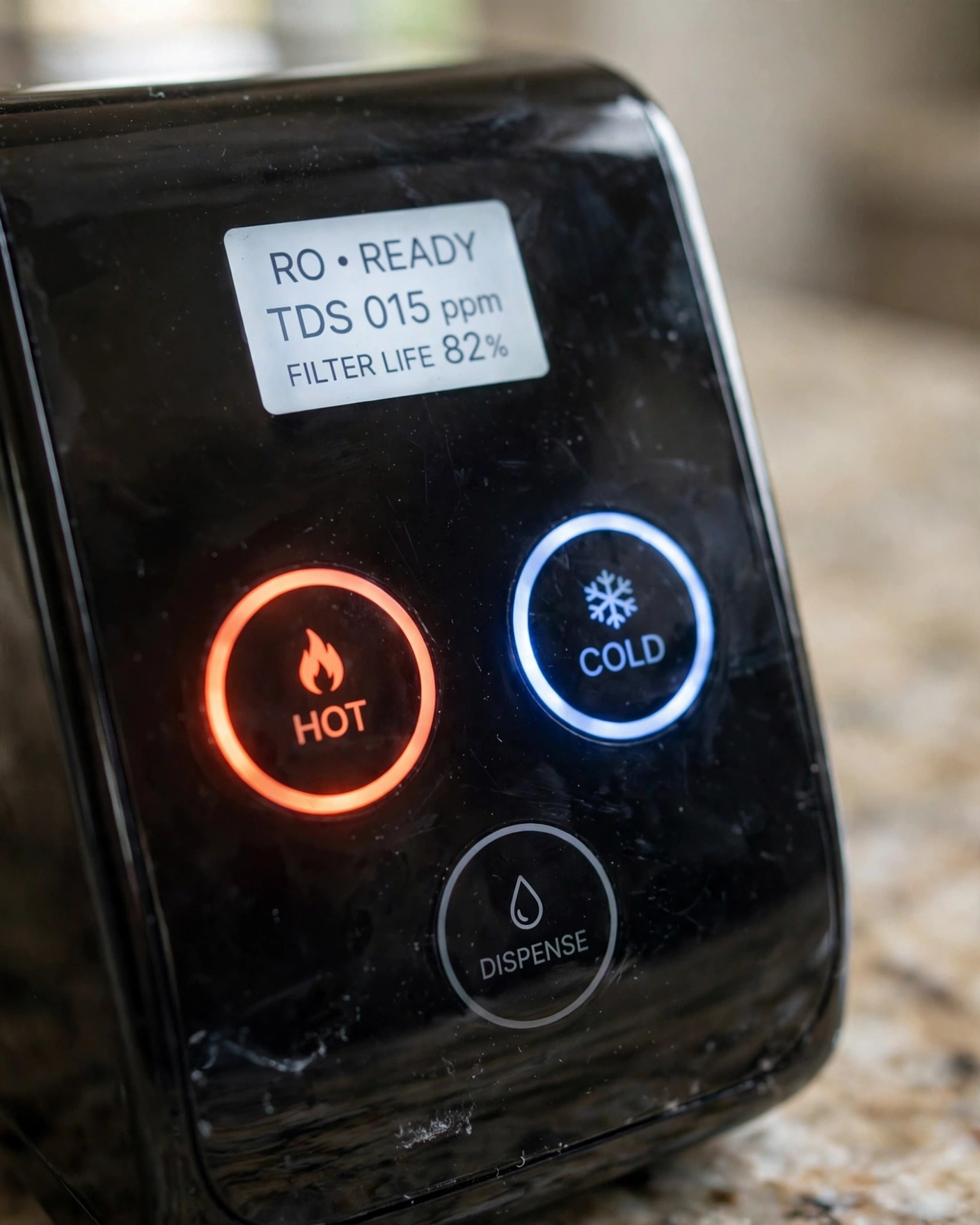 Close-up of a countertop RO control panel with hot and cold temperature buttons